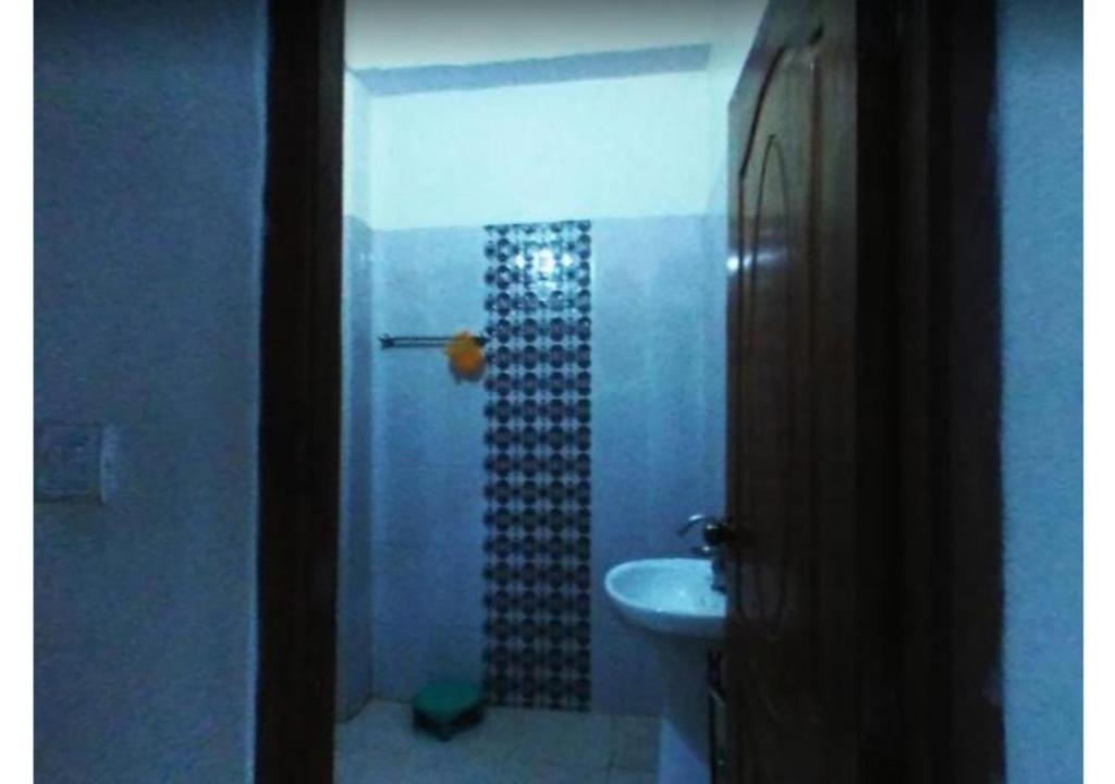 a bathroom with a shower and a sink at Hotel Pratiksha in Solan
