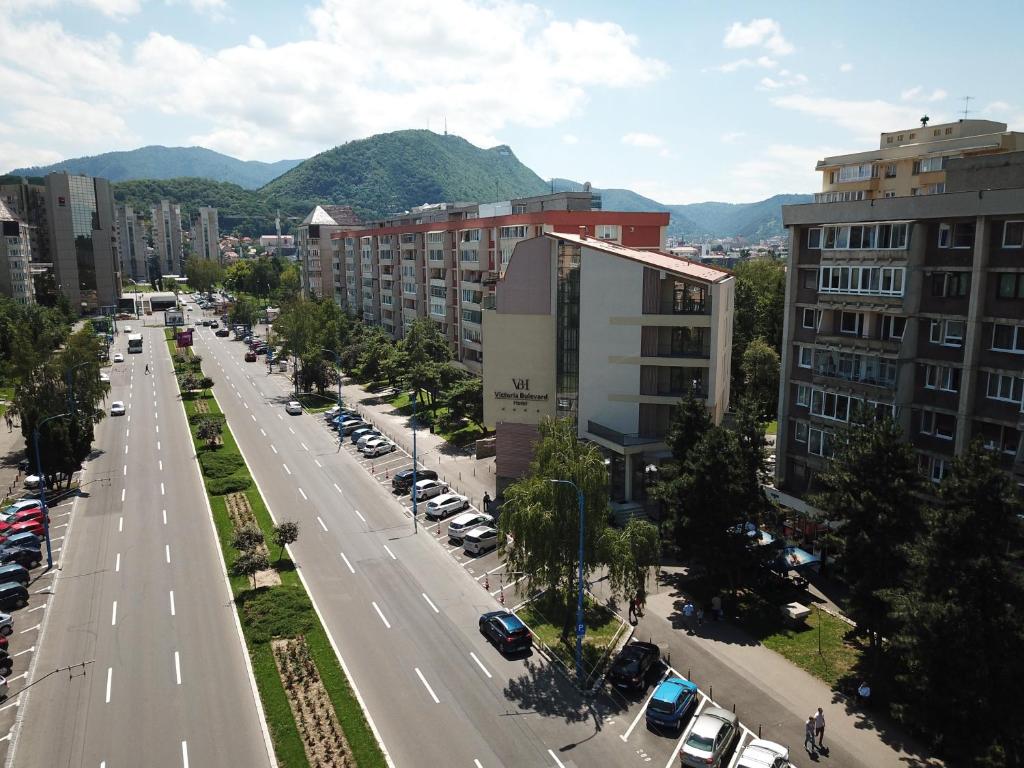 une vue aérienne sur une rue de la ville avec des voitures et des bâtiments dans l'établissement Victoria Bulevard Hotel, à Braşov