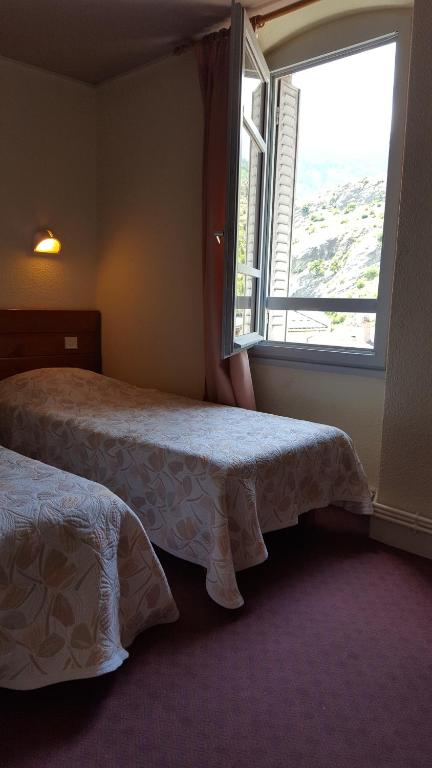 Postel nebo postele na pokoji v ubytování Hôtel Restaurant Glaizette