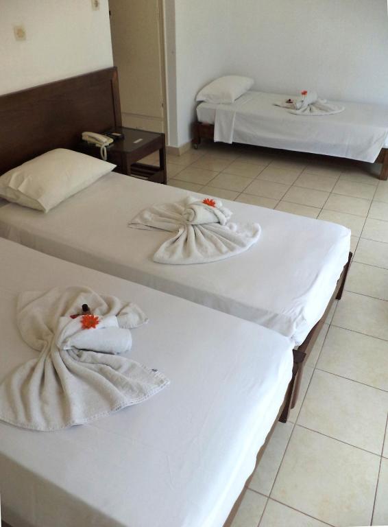 Postel nebo postele na pokoji v ubytování Poseidon Hotel