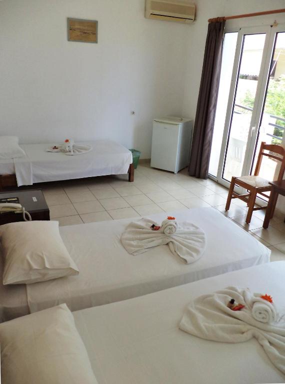 Postel nebo postele na pokoji v ubytování Poseidon Hotel