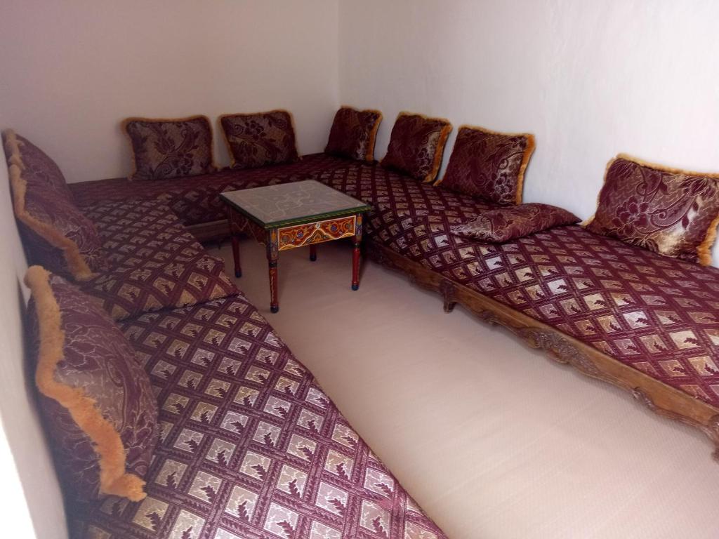 a living room with a couch and a table at Maison Saadia in Rabat
