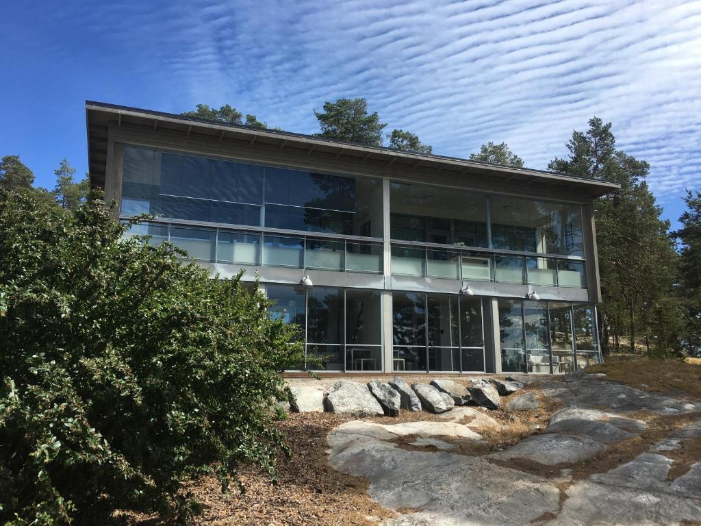 a building with glass windows on top of a hill at Holiday Home Birdie in Naantali