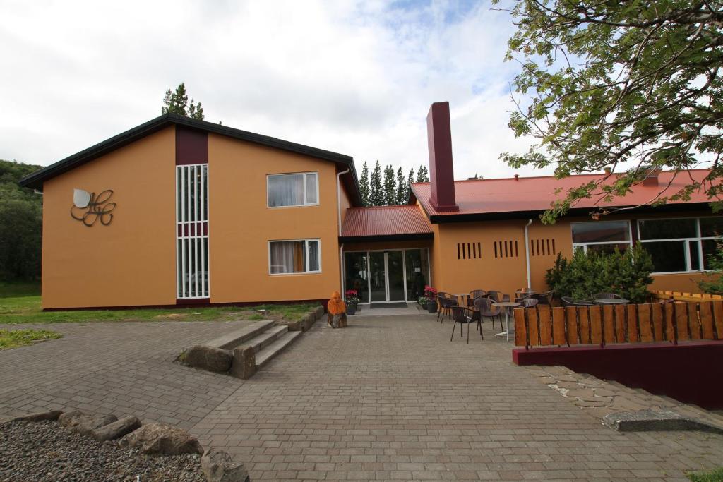 a building with a patio in front of it at Hotel Hallormsstadur in Hallormsstaður