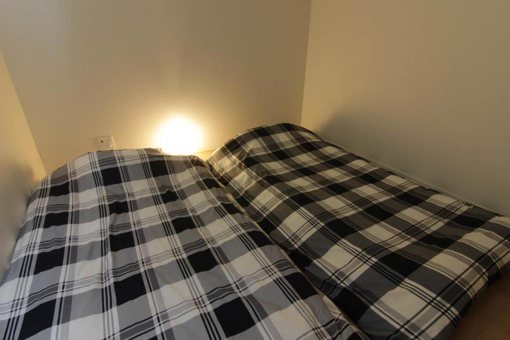 Postel nebo postele na pokoji v ubytování Guesthouse Tokushima