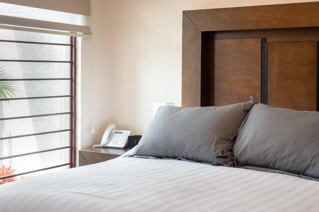 Postel nebo postele na pokoji v ubytování Hotel Posada XR