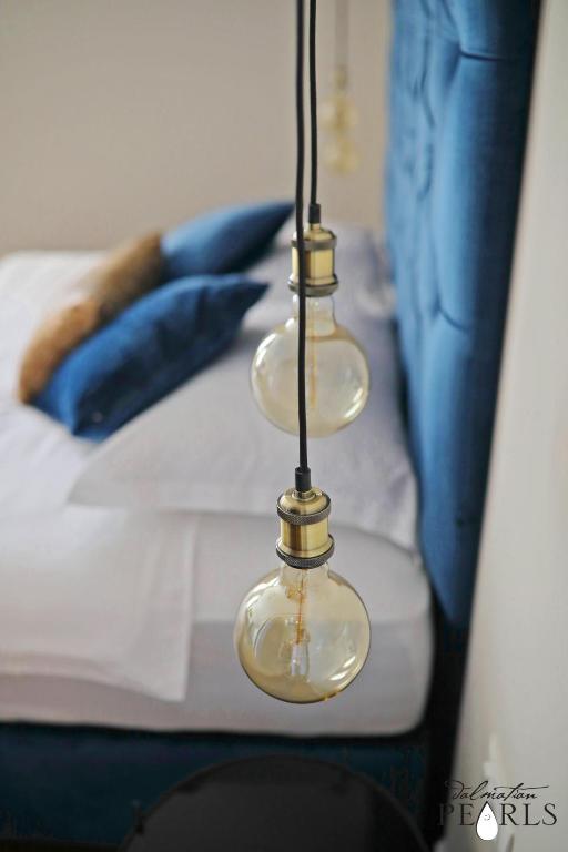 Postel nebo postele na pokoji v ubytování Three Pearls Deluxe Rooms & Studios