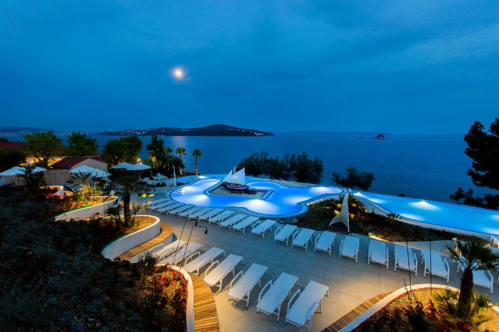 een afbeelding van een zwembad in een resort 's nachts bij Amadria Park Camping Trogir - Apartments in Seget Vranjica