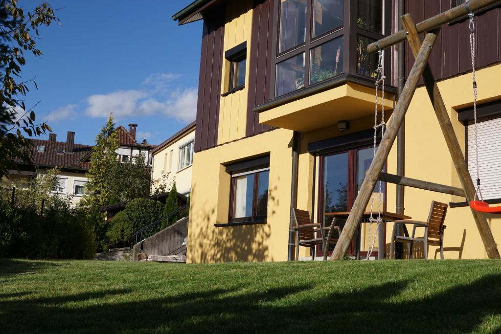 een huis met een schommel in een tuin bij Ferienwohnung Duttental in Tuttlingen