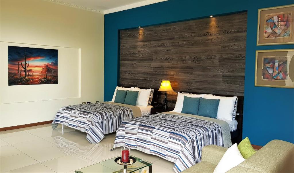 Postel nebo postele na pokoji v ubytování Alameda Cariari Boutique Hotel