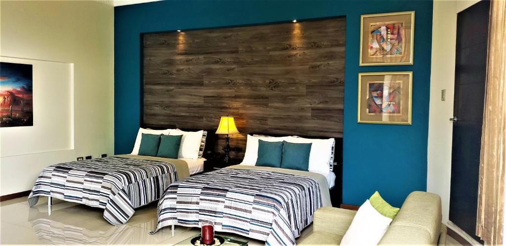 Postel nebo postele na pokoji v ubytování Alameda Cariari Boutique Hotel