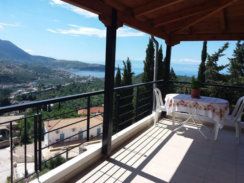 a balcony of a house with a table and a view at Apartments Aneta's House in Himare