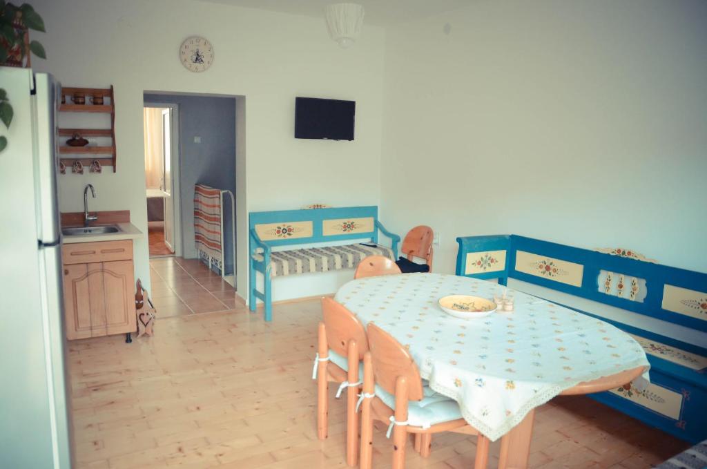 a room with a table and chairs and a crib at Noira House in Turda
