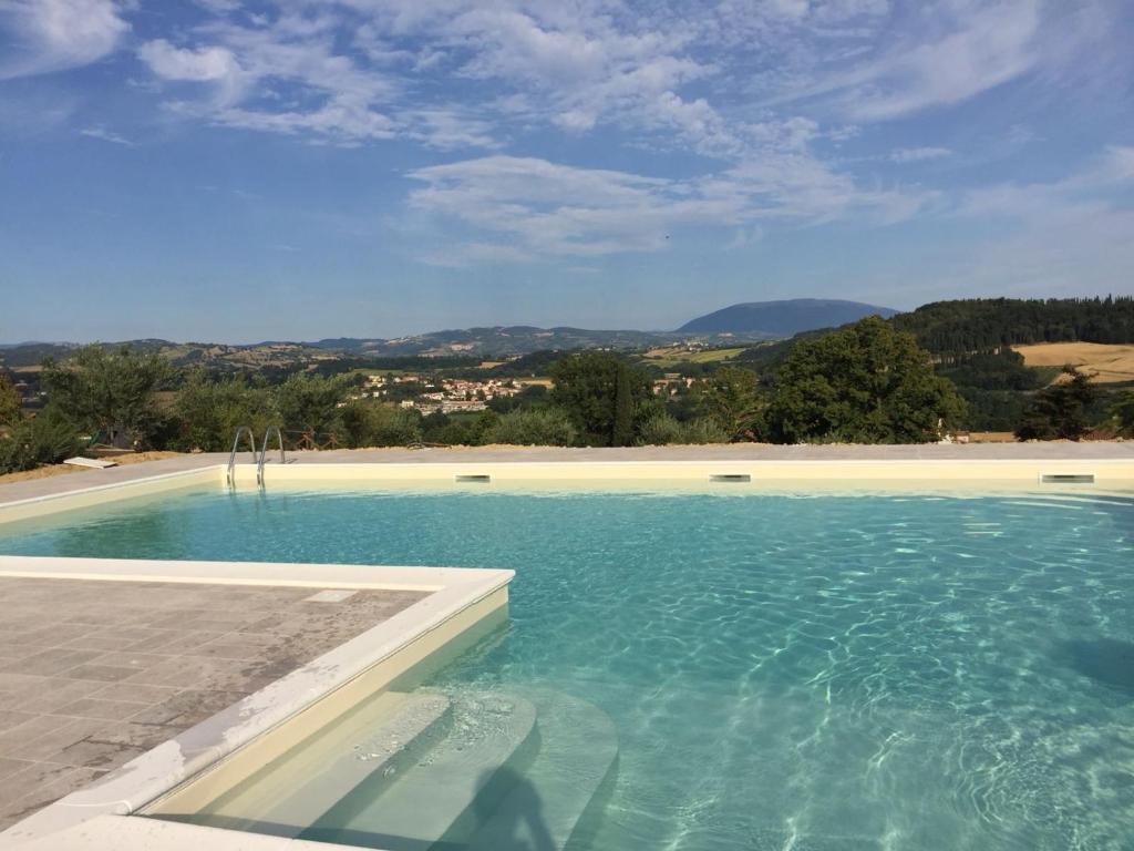 a swimming pool with a clear blue water at Agriturismo Villalta in Ponte Felcino