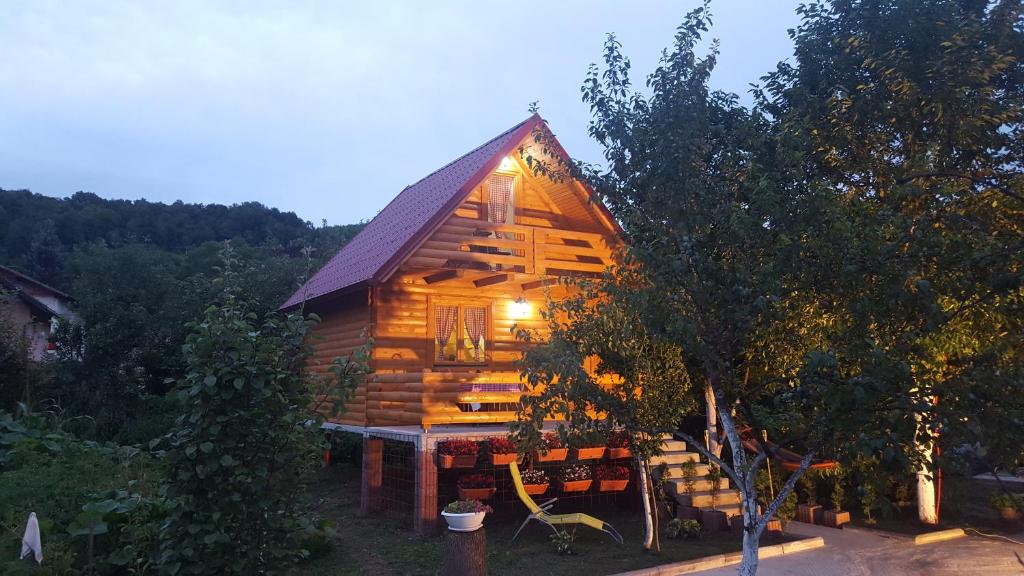 a log cabin with a light on the side of it at Vacation home SAJRA in Kulen Vakuf