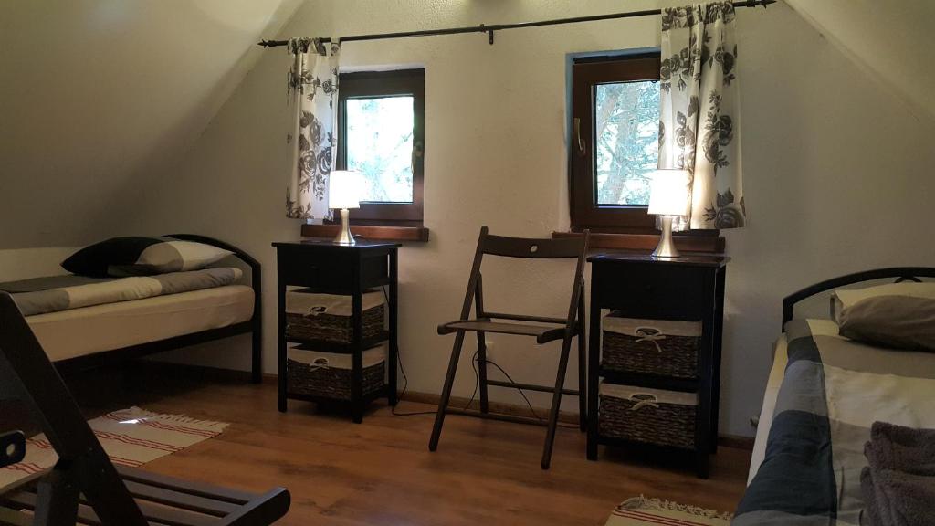 Postel nebo postele na pokoji v ubytování Osada pod Czerwonym Dębem - Czarny Młyn