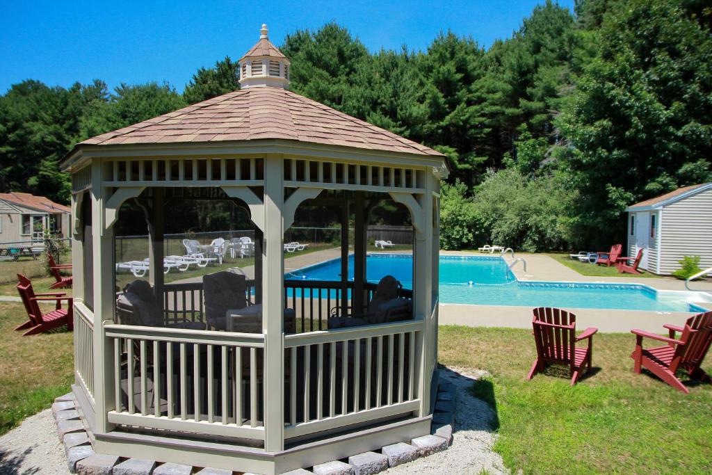 a gazebo in a yard with a pool at Kennebunk Gallery Motel and Cottages in Kennebunk