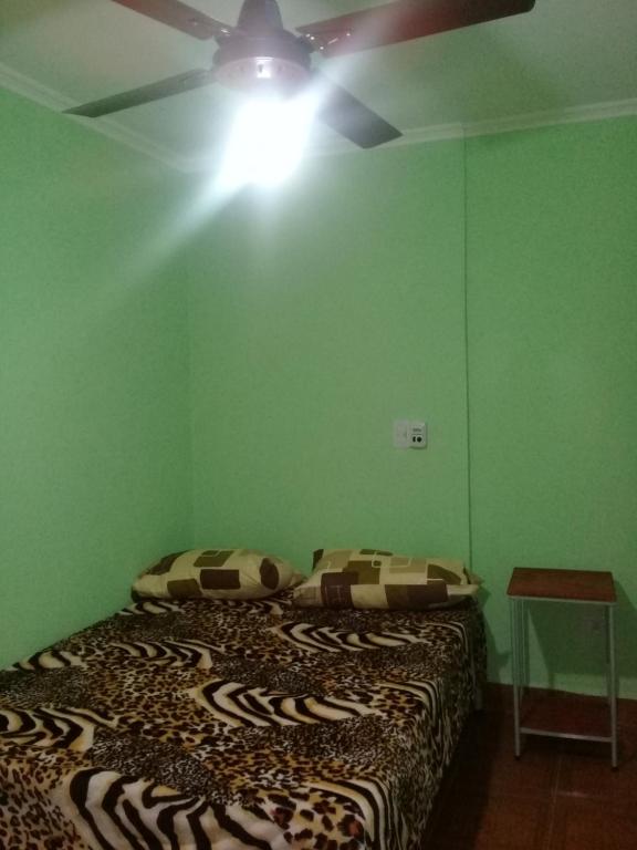 a bedroom with a bed and a ceiling fan at Habitaciones Daniel in Termas de Río Hondo