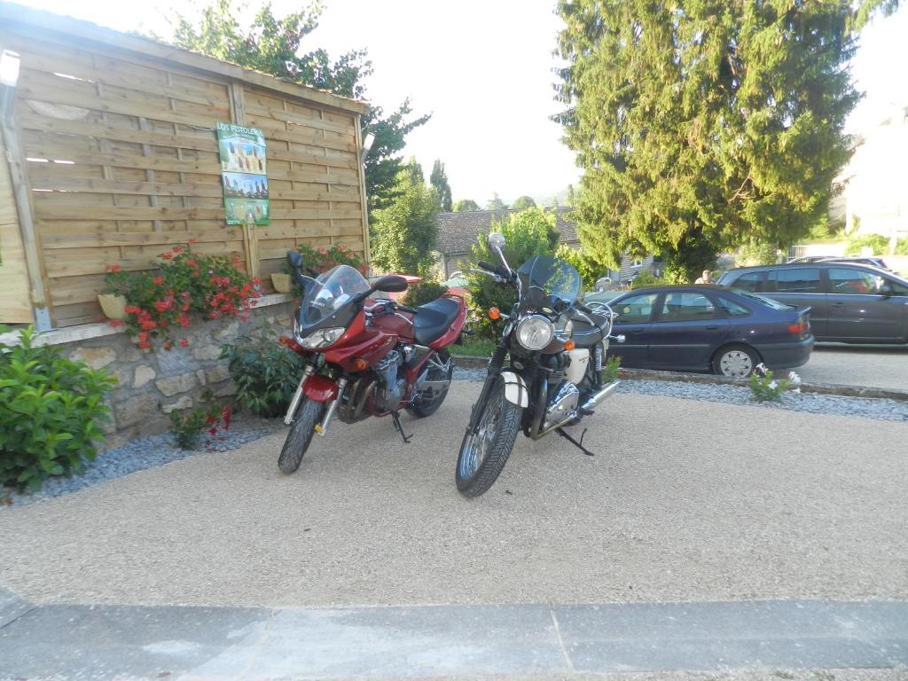 two motorcycles parked in front of a building at Hotel Belle Vue in Souillac