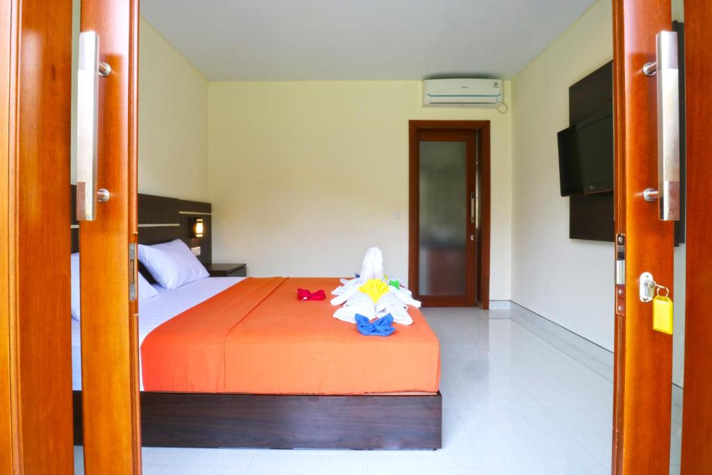 Postel nebo postele na pokoji v ubytování Gempita House Bali