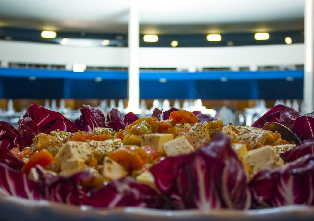 a plate of food with vegetables on a table at Corvino Resort in Monopoli