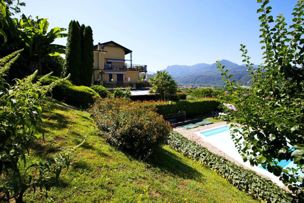 a house on a hill with a swimming pool at Residenza Moncucco in Luino
