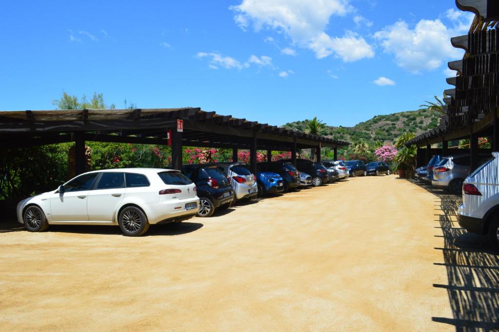 a row of cars parked in a parking lot at Residence Fenicia in Villasimius