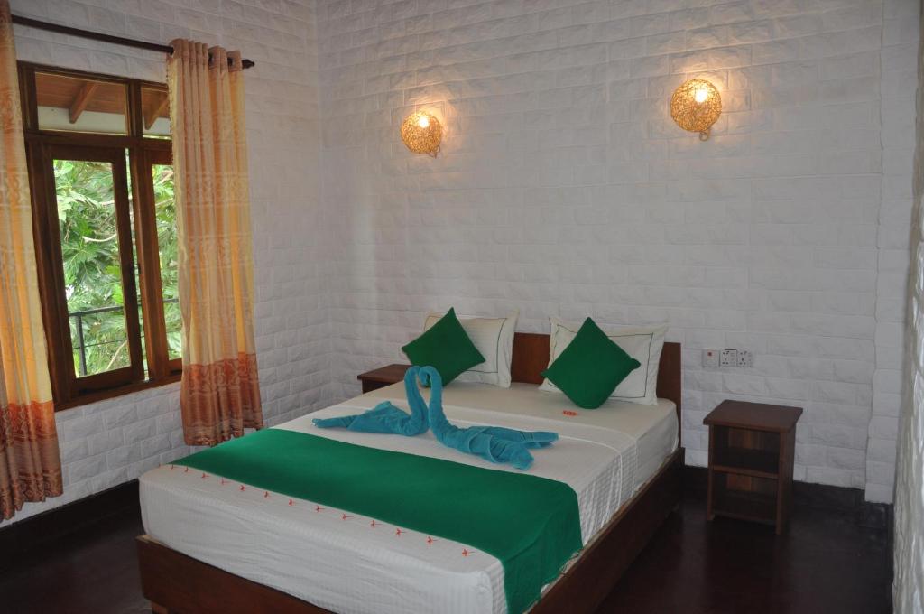 Postel nebo postele na pokoji v ubytování Liyon Rest sigiriya