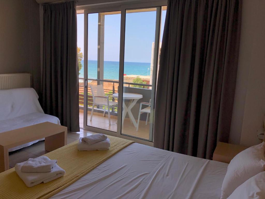 ハニア・タウンにあるKleanthi Studiosのベッド付きのホテルルームで、海の景色を望めます。