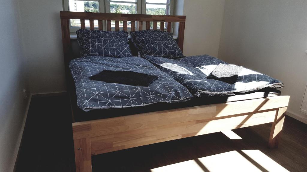 a bed with blue comforter and pillows on it at Apartment MDK Sokolov in Sokolov