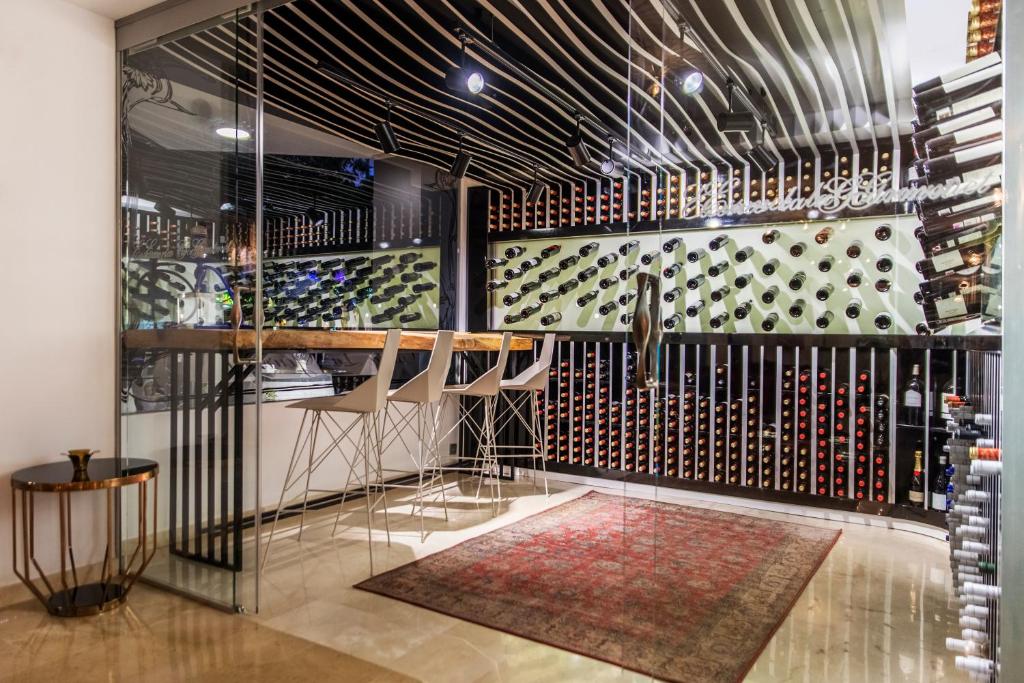 a wine tasting room with a wall of wine bottles at Essence Hotel Boutique in Torremolinos