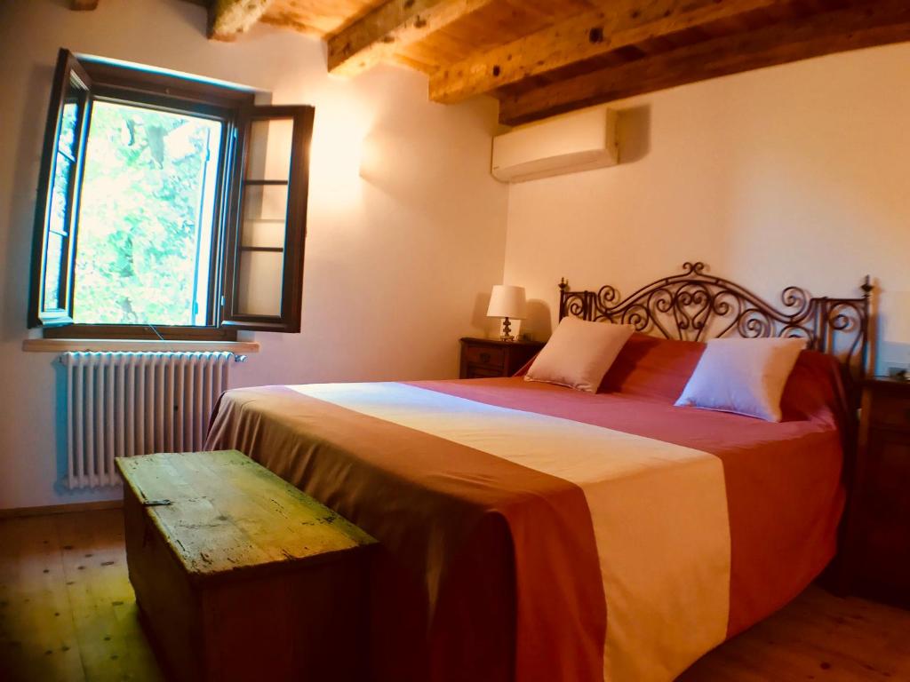 Ένα ή περισσότερα κρεβάτια σε δωμάτιο στο Regina nel cuore del Veneto