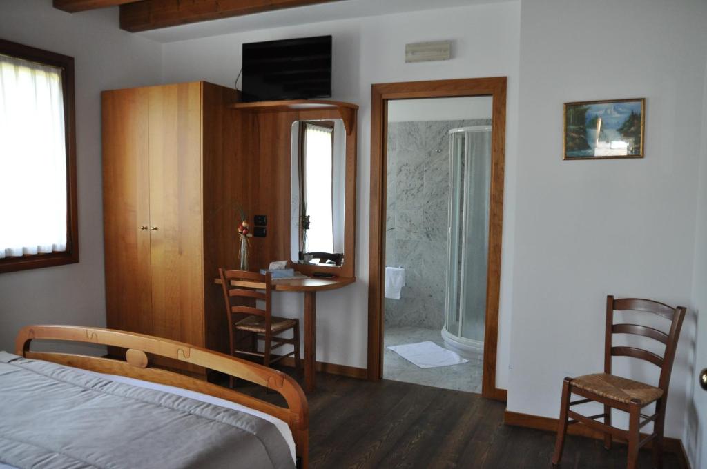 Łóżko lub łóżka w pokoju w obiekcie Agriturismo Ancillotto