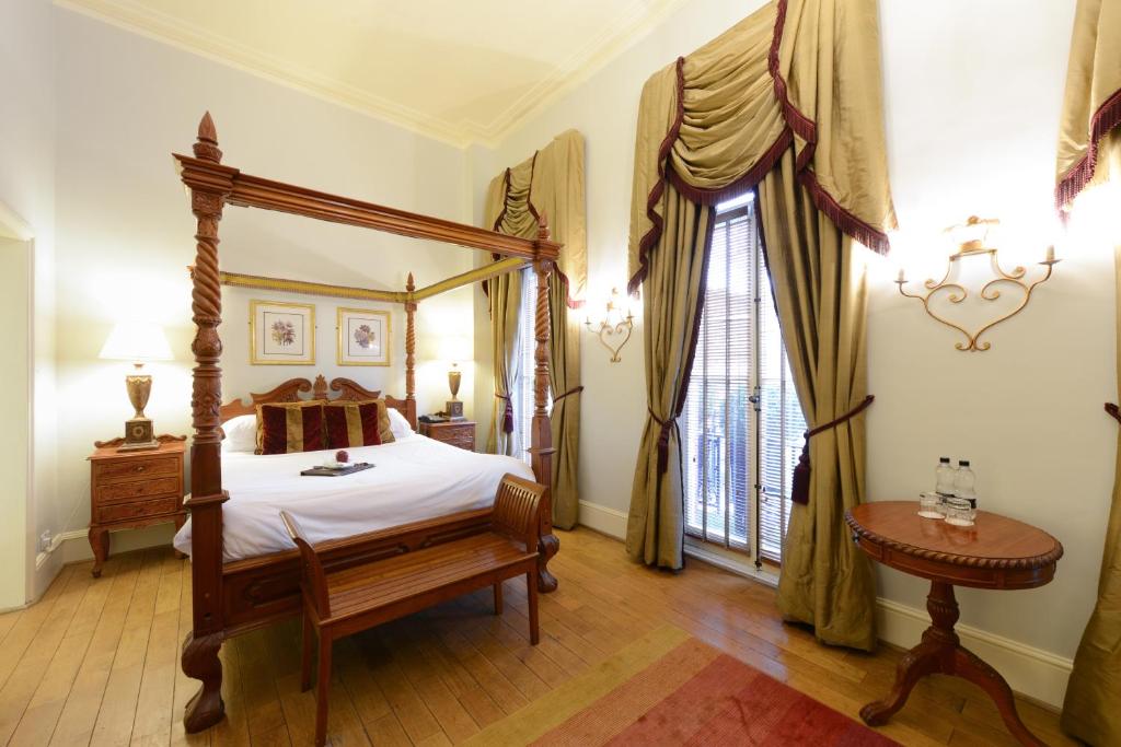 1 dormitorio con cama con dosel y ventana en Twenty Nevern Square Hotel, en Londres