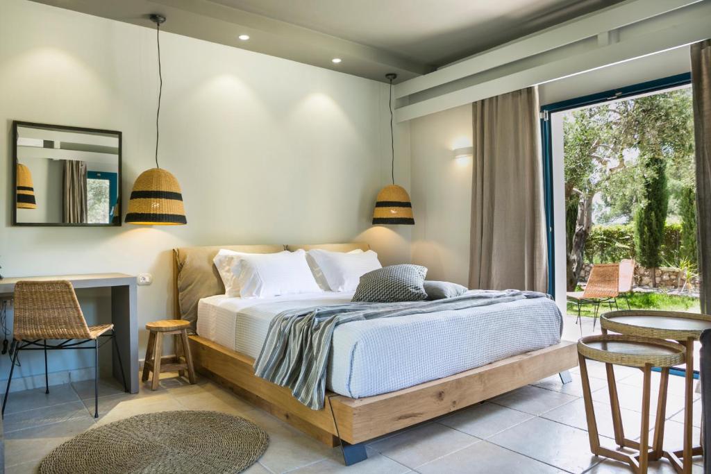 a bedroom with a bed and a table and chairs at Avithos Resort Hotel in Svoronata