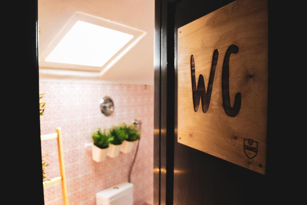a door to a bathroom with plants on the wall at Beach House São Pedro in São Pedro do Estoril