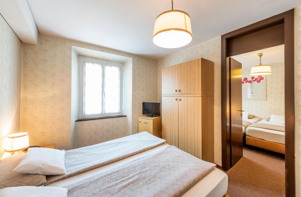 Postel nebo postele na pokoji v ubytování Albergo Ristorante Svizzero