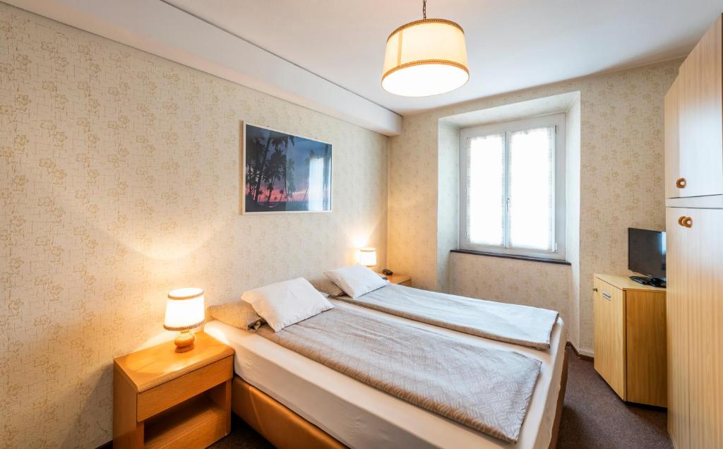 Postel nebo postele na pokoji v ubytování Albergo Ristorante Svizzero