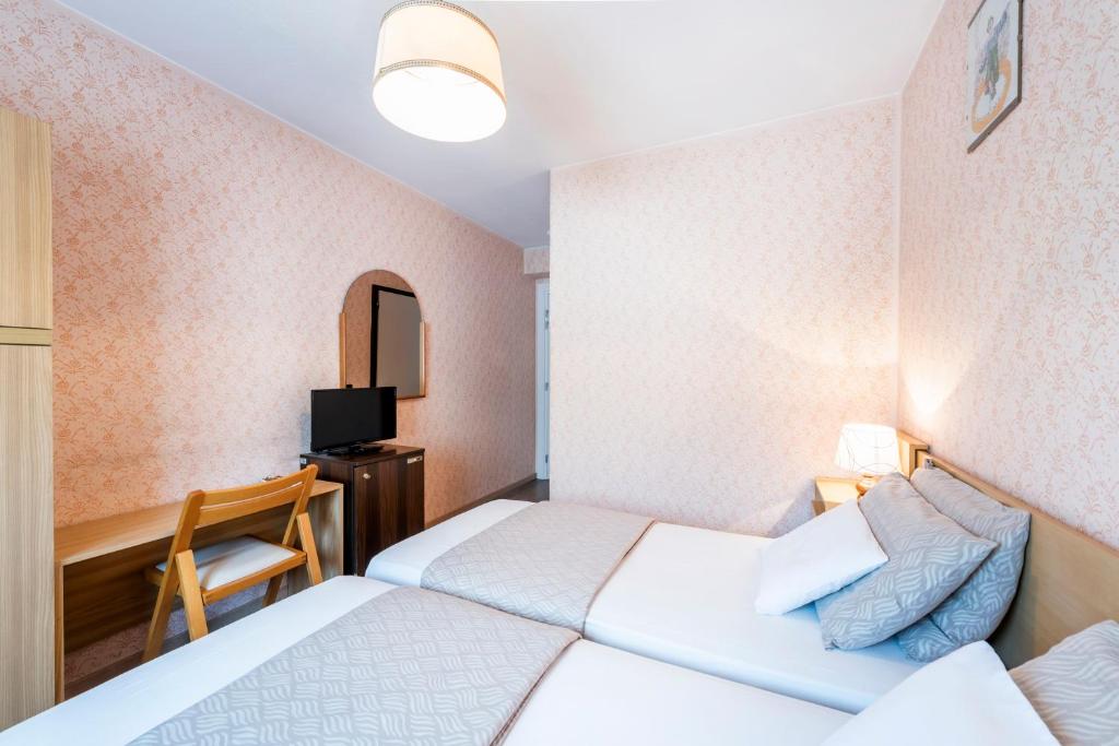 Postel nebo postele na pokoji v ubytování Albergo Ristorante Svizzero