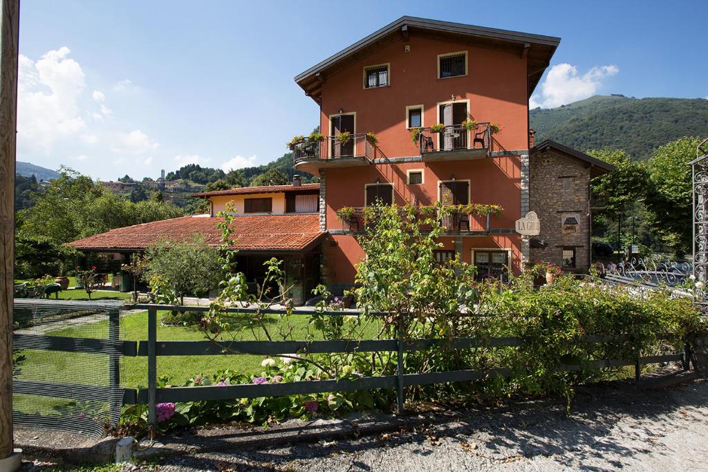 a house with a fence in front of it at La Griglia Hotel in Argegno