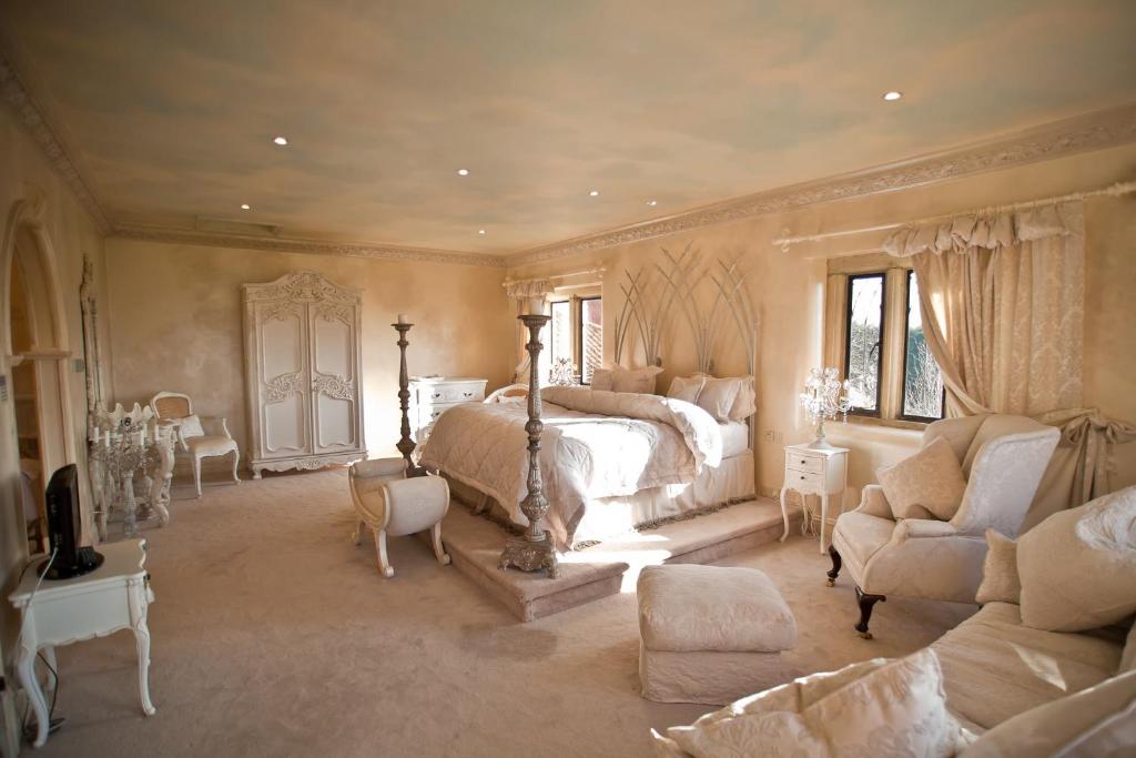 a bedroom with a bed and a couch and chairs at Manor Court in Newark-on-Trent