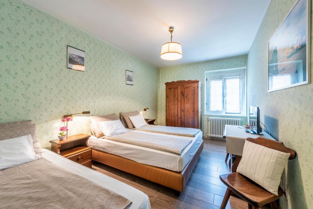 Postel nebo postele na pokoji v ubytování Albergo Ristorante Svizzero