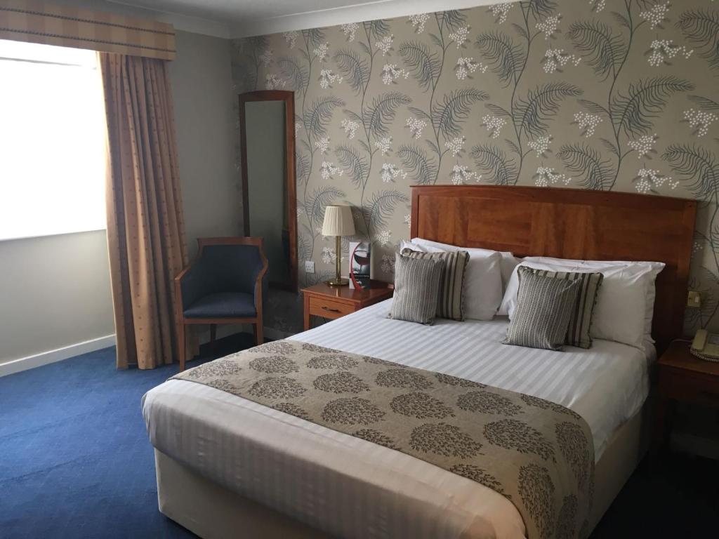 a hotel room with a bed and a window at Red Lion Hotel in Basingstoke