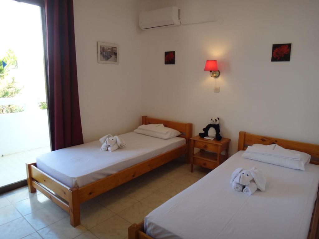 Postel nebo postele na pokoji v ubytování Amfi Apartments