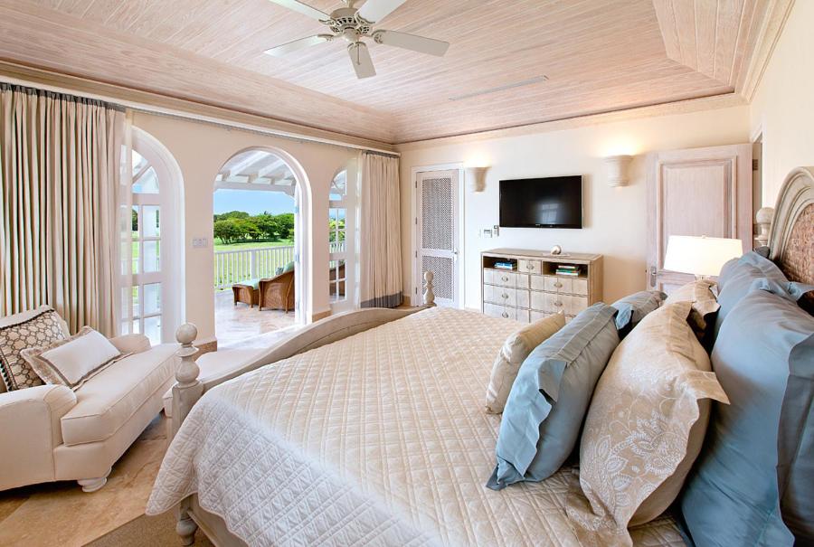 a large bedroom with a bed and a couch at Howzat! by Island Villas in Saint James