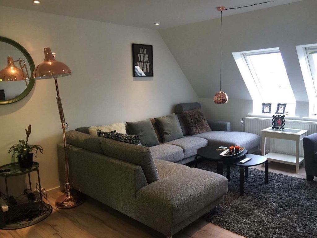 a living room with a couch and a table at 2 BR apartment on walk street in Frederikshavn