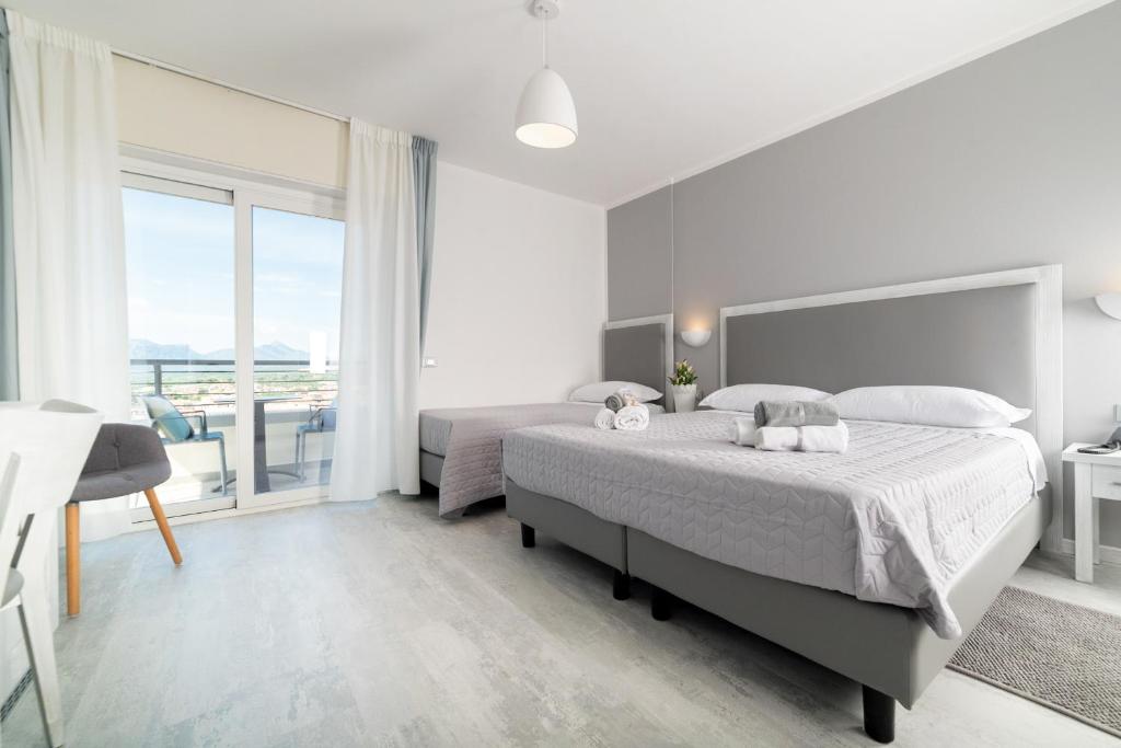 Postel nebo postele na pokoji v ubytování Hotel Gli Ulivi