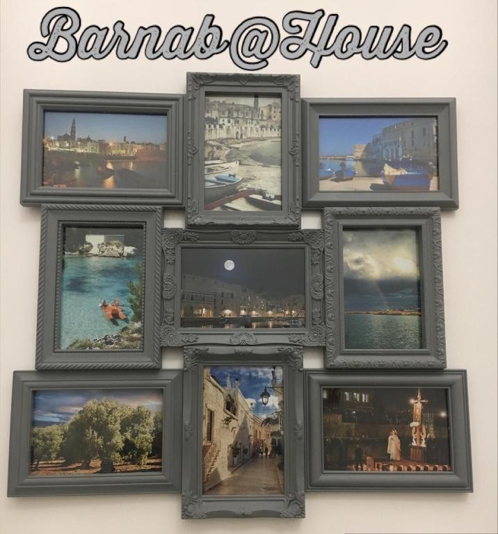 a group of pictures in frames on a wall at Barnab@House in Monopoli