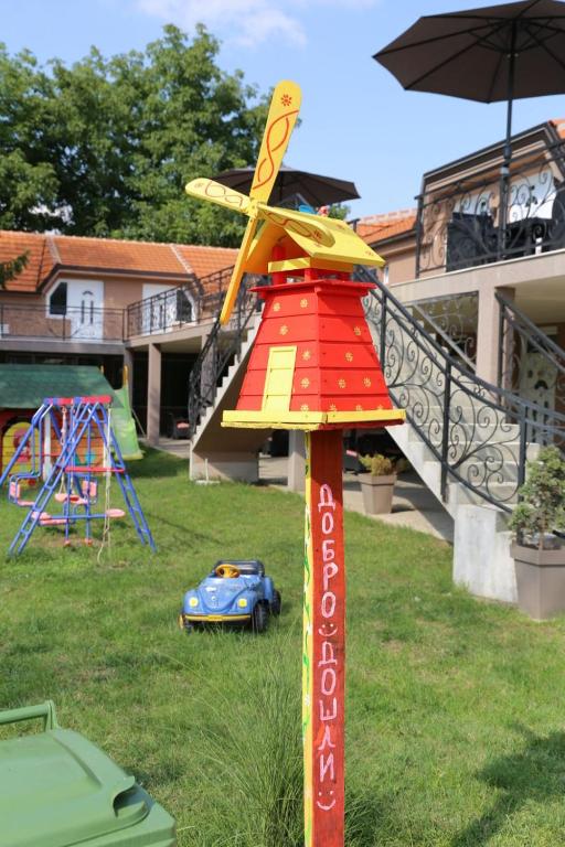 a toy airplane on a pole in a yard at Apartmani "ROSHU" in Soko Banja