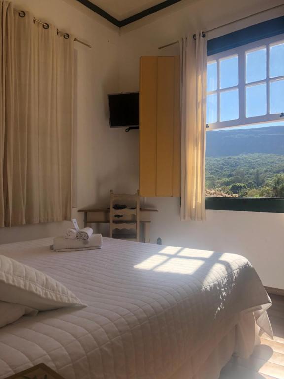 Un pat sau paturi într-o cameră la Pousada Vovô Chiquinho